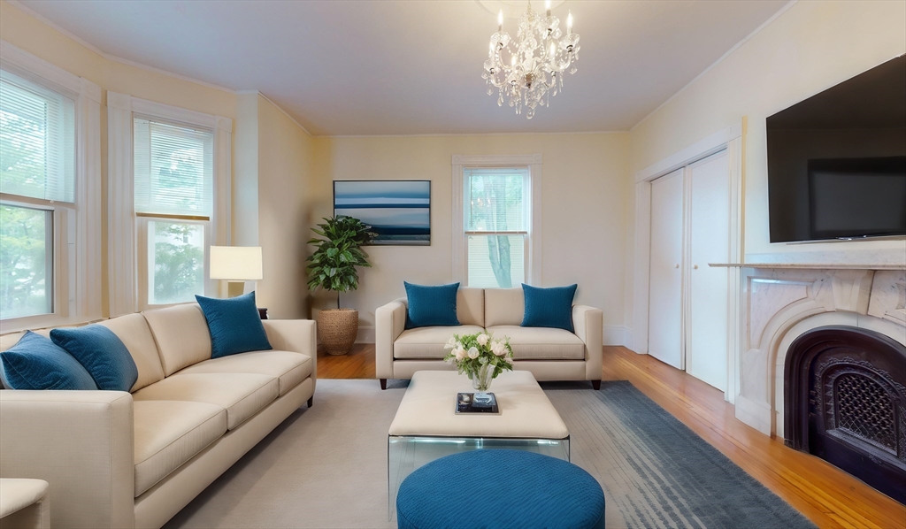 a living room with furniture a fireplace and a flat screen tv