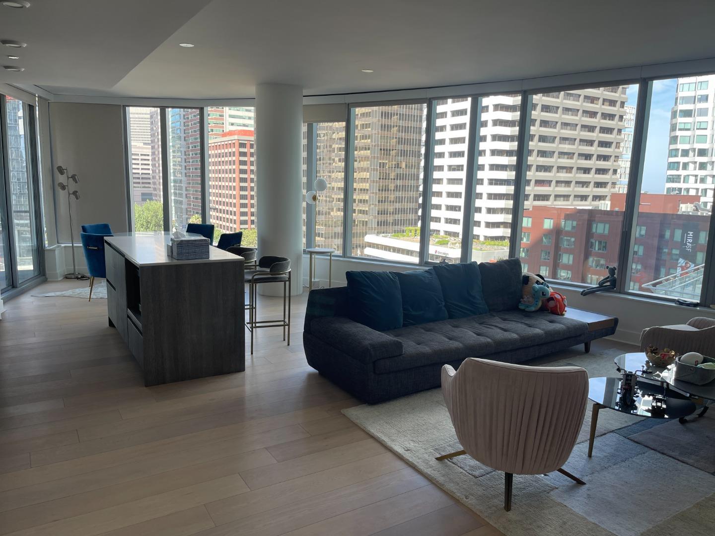 a living room with furniture and large windows