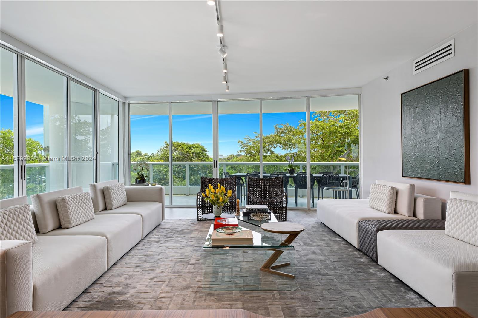 a living room with furniture and floor to ceiling window