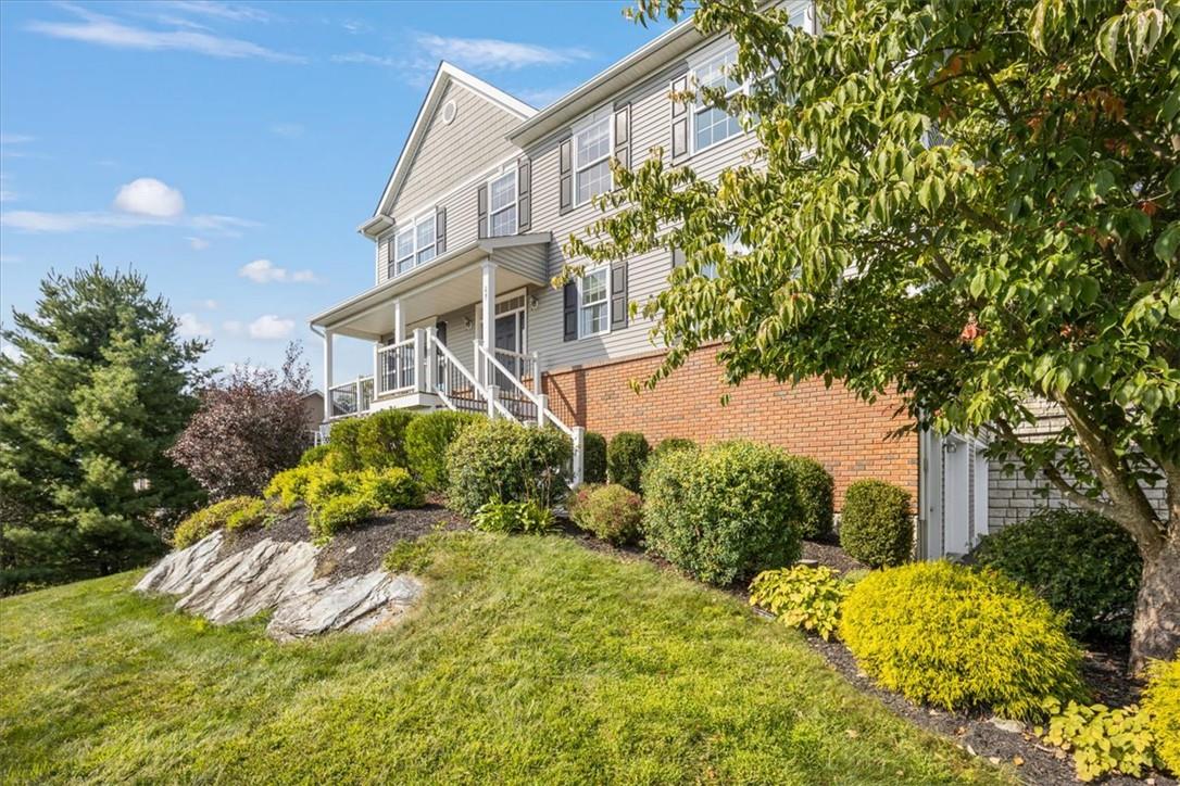 Front of property featuring a professionally landscaped yard