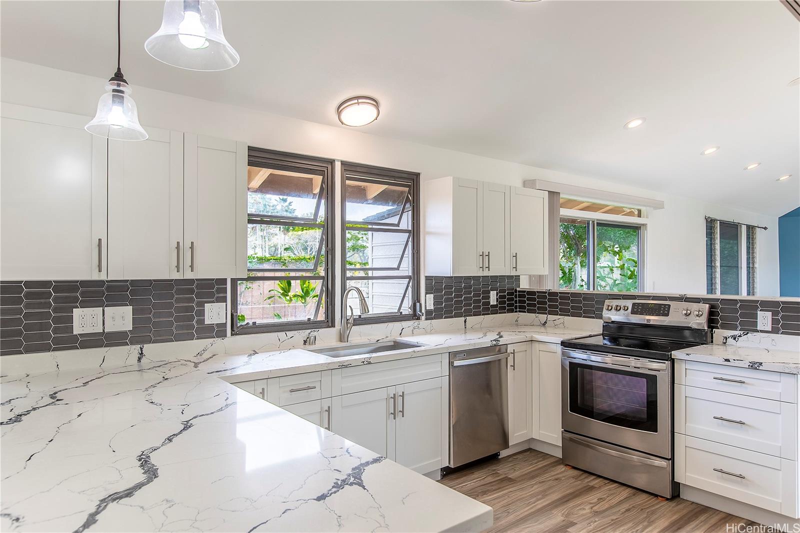 a kitchen with a sink stove and cabinets