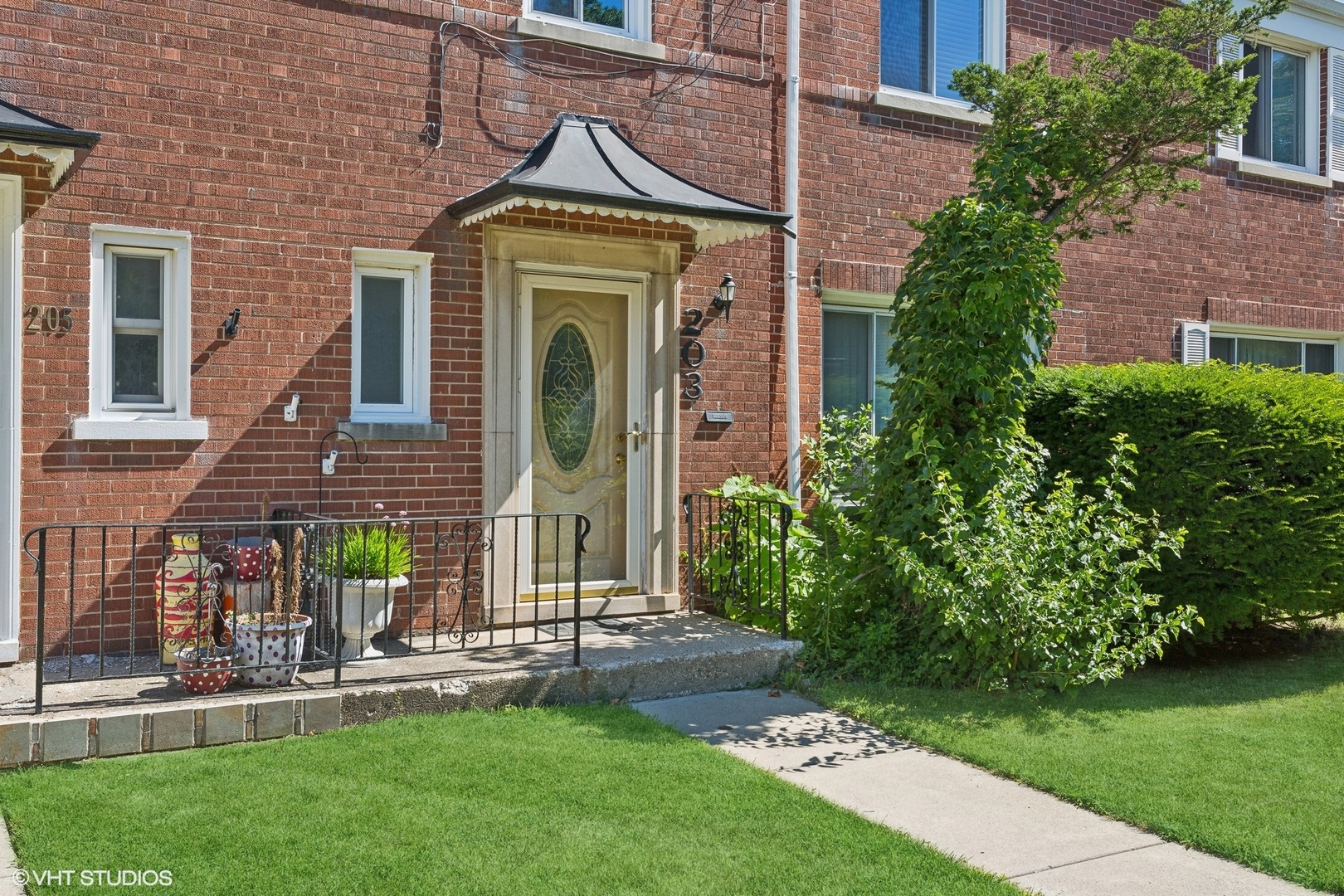 a front view of a house with a garden