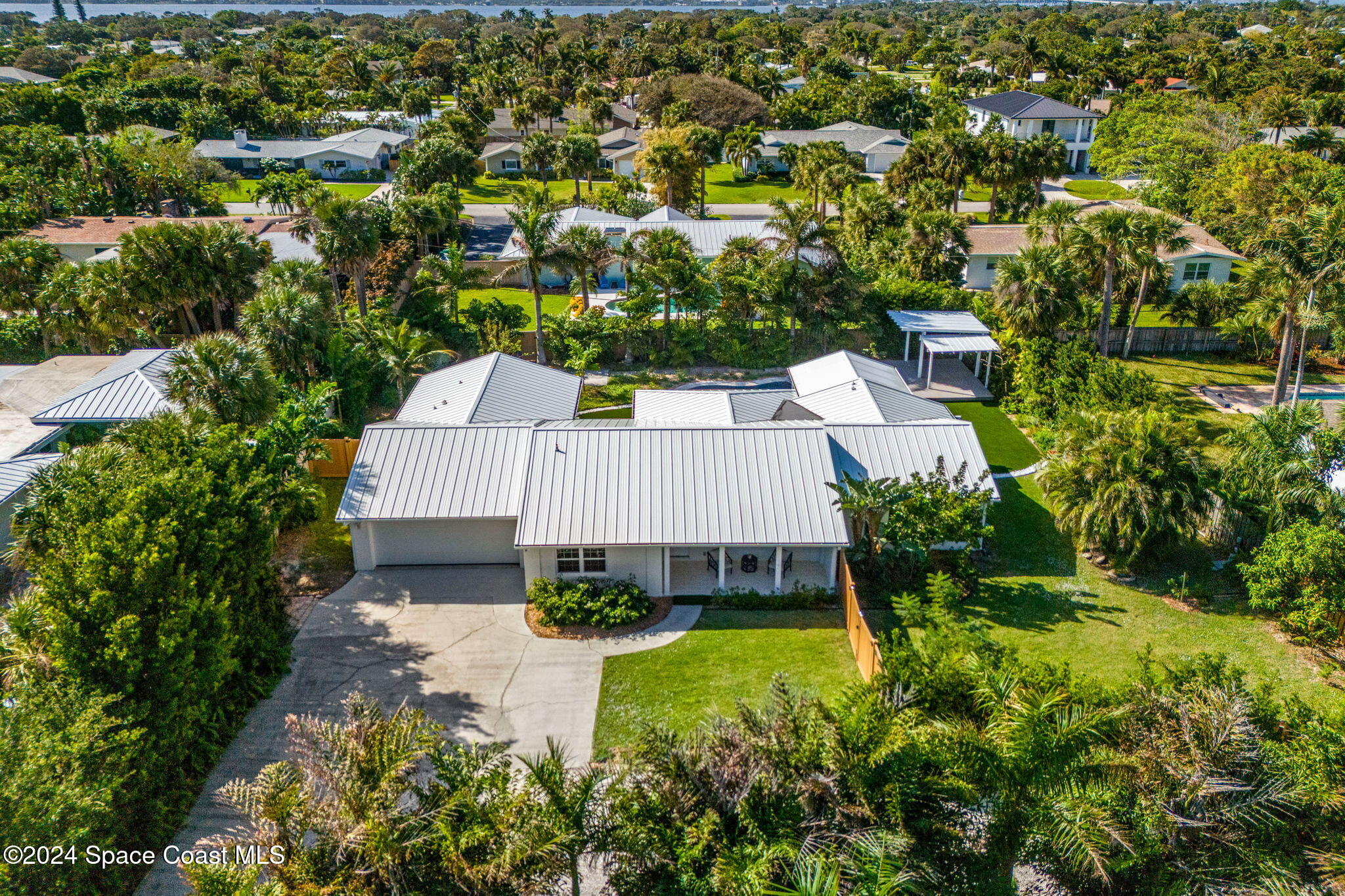 an aerial view of a house with a yard basket ball court and outdoor seating