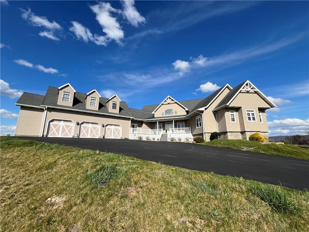 a front view of a house with yard and garage