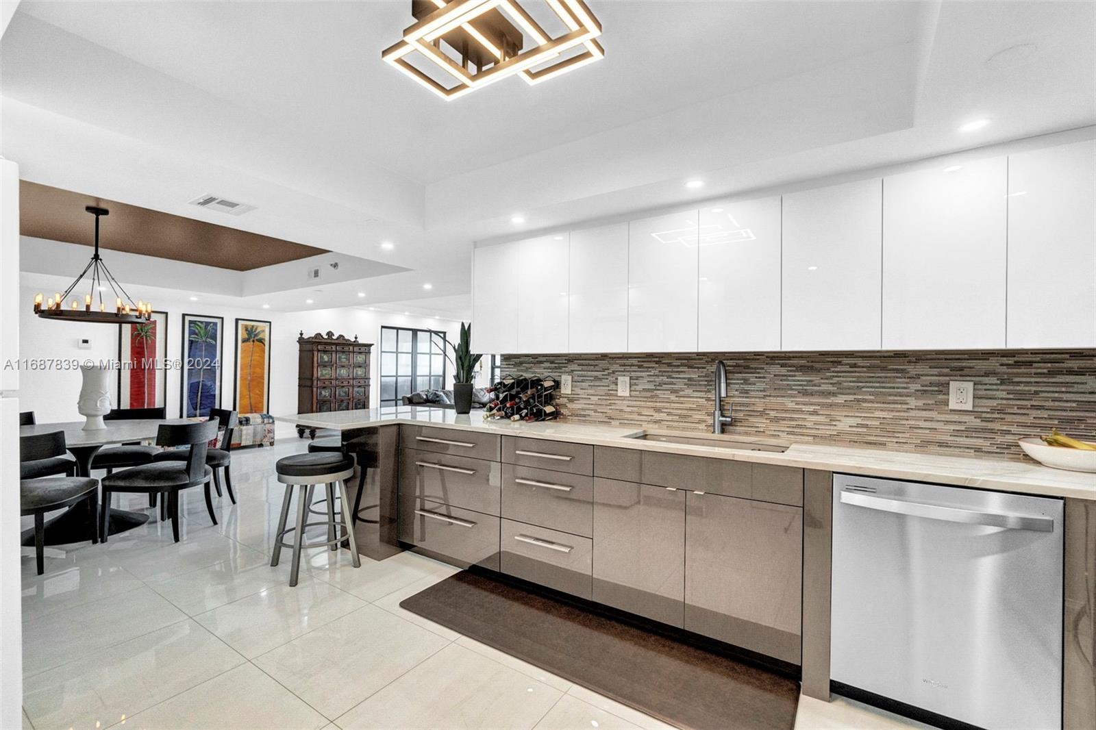 a kitchen with cabinets and chairs