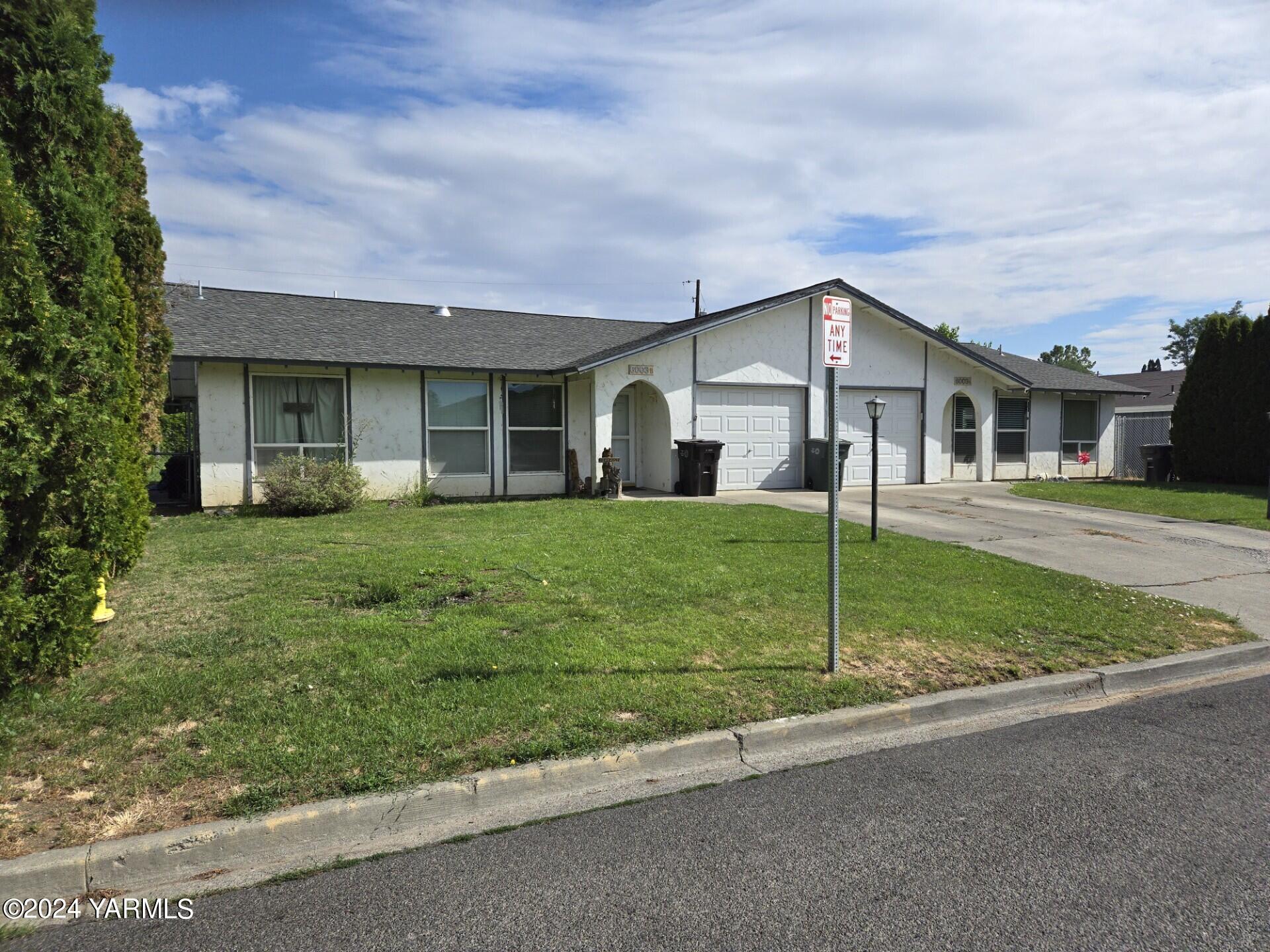 a front view of house with yard and green space