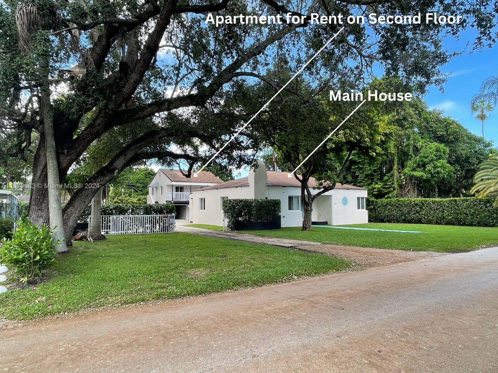 a house that has a tree in front of it