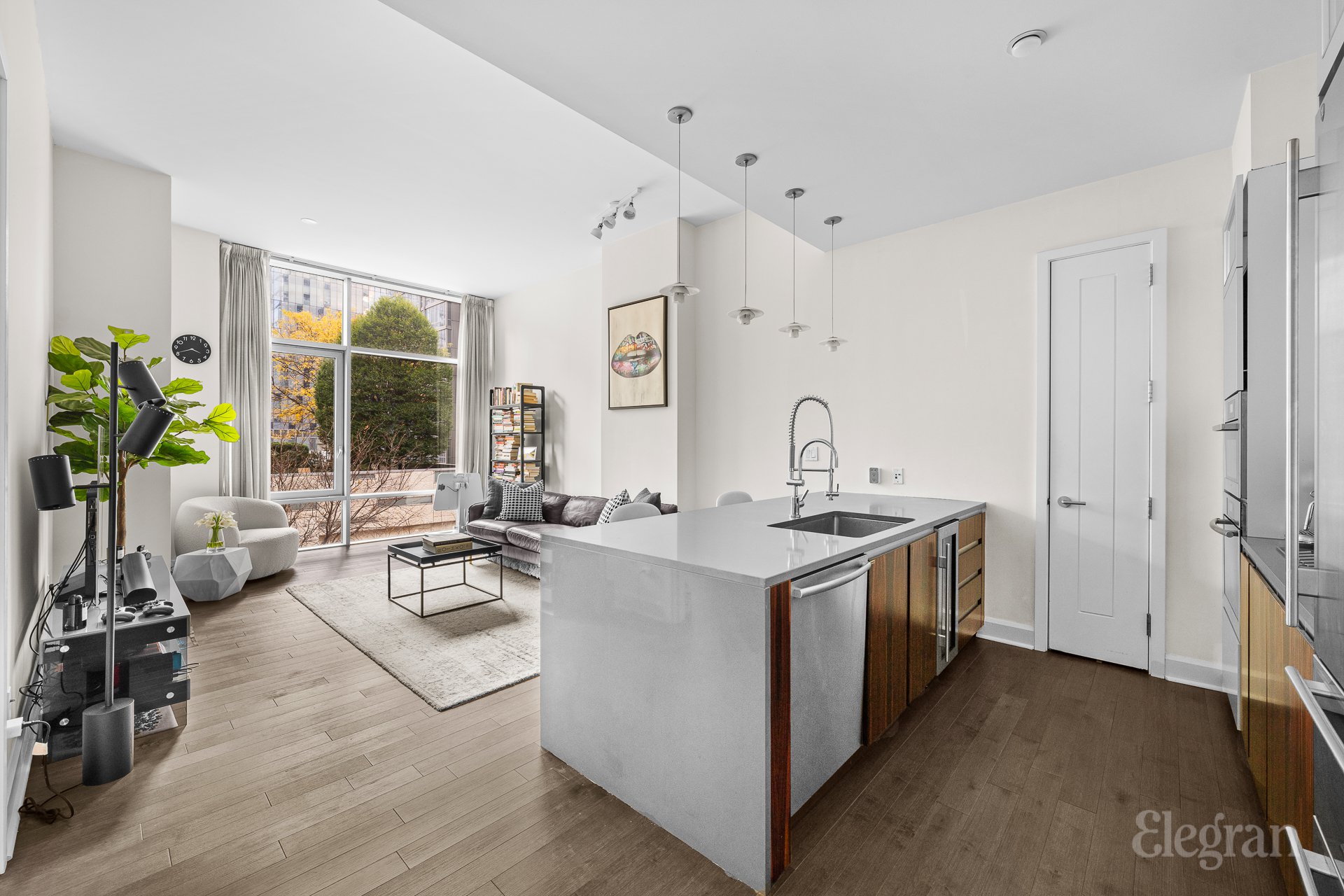 a kitchen with a sink stove and wooden floor