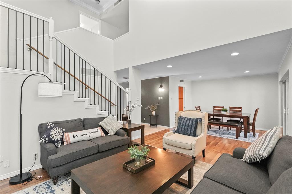 a living room with furniture potted plant and a rug