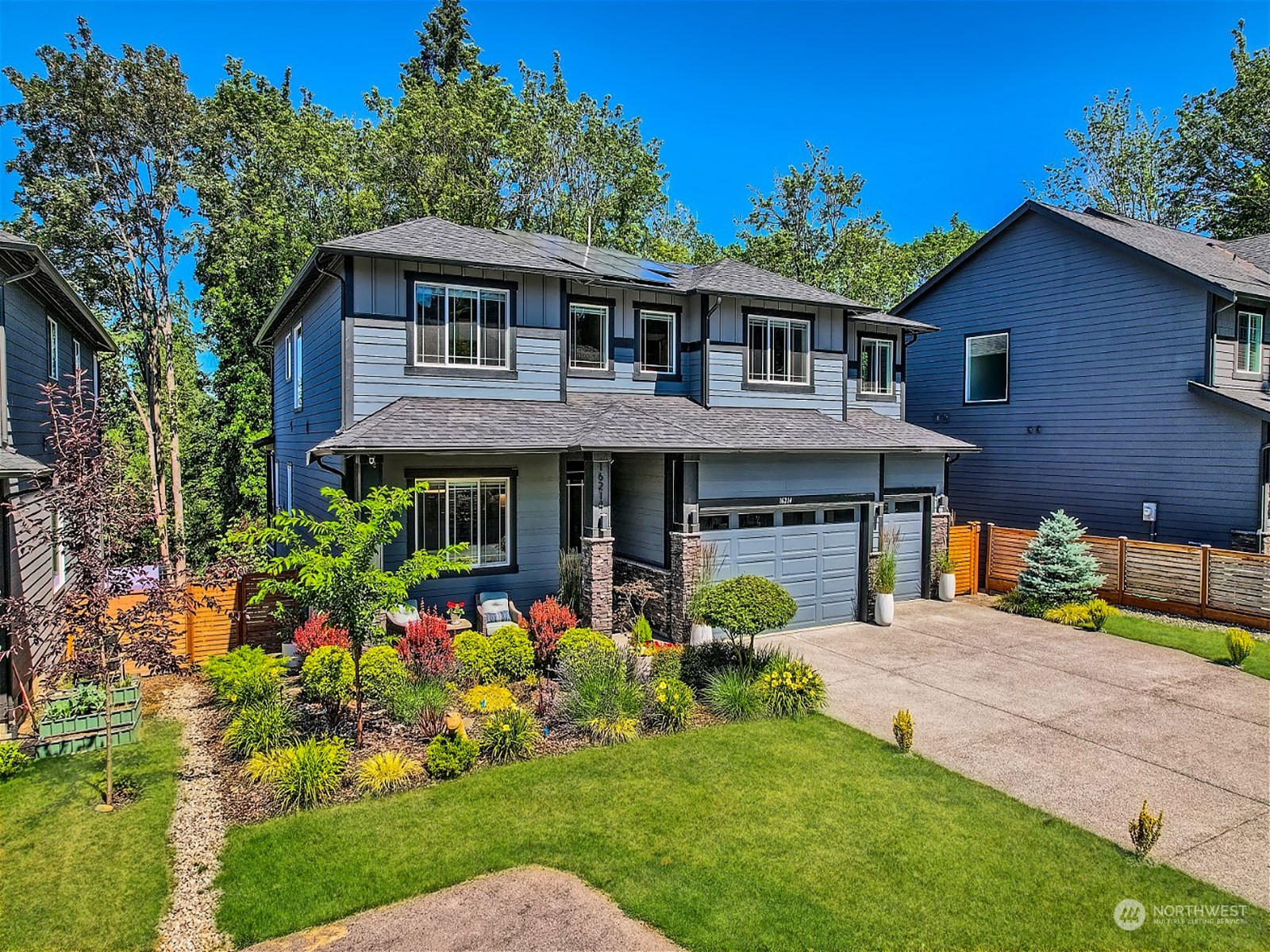 a front view of a house with a garden