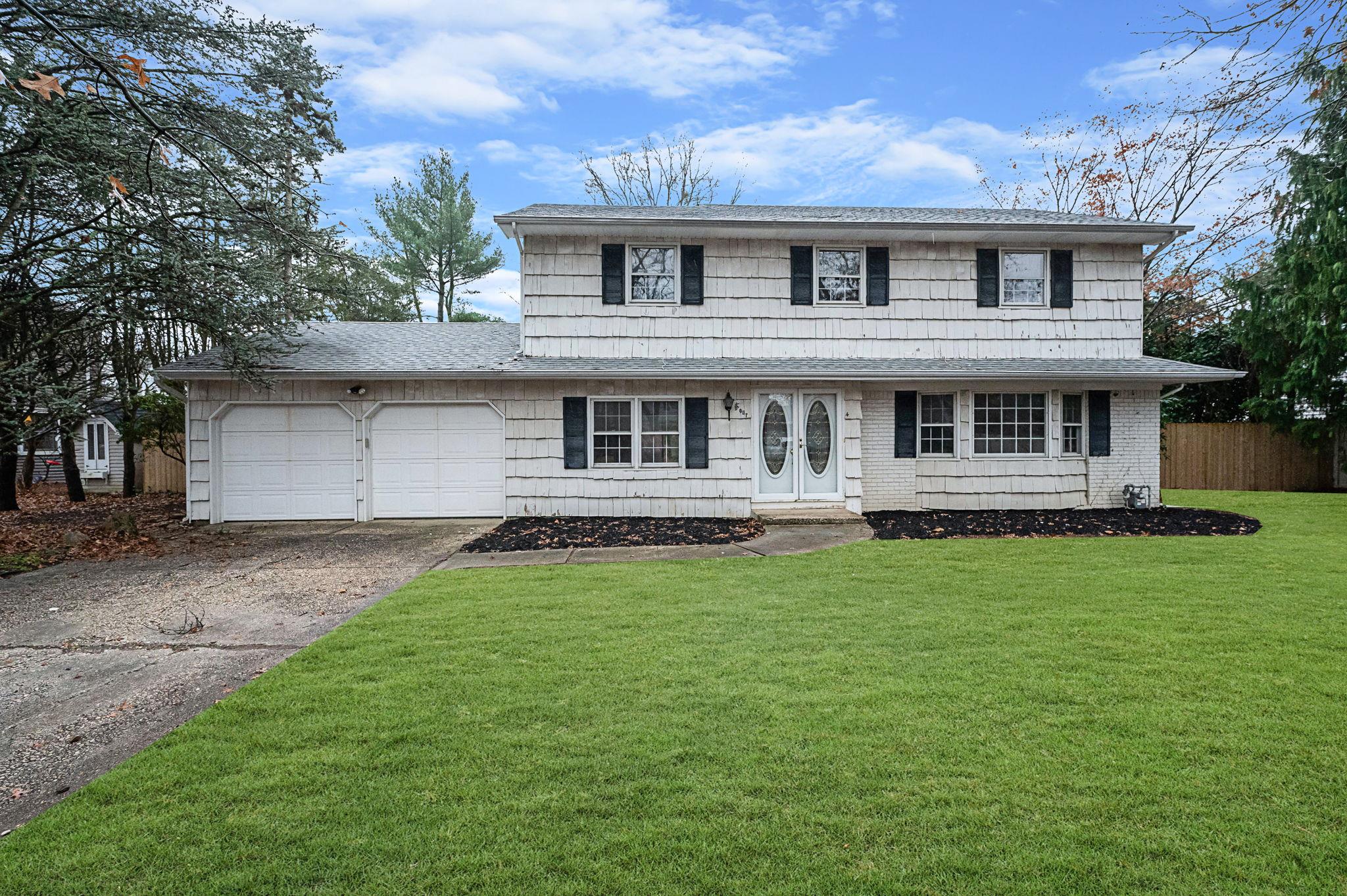 View of front of home featuring a garage and a front lawn