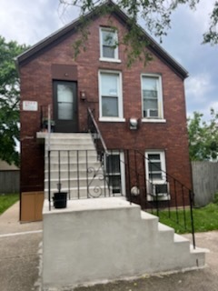 a front view of a house with a garden