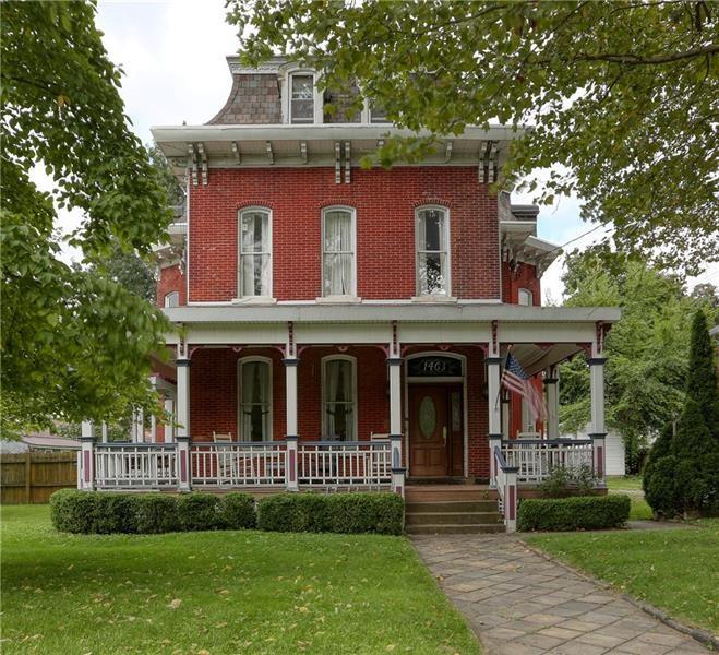 a view of brick house with a yard