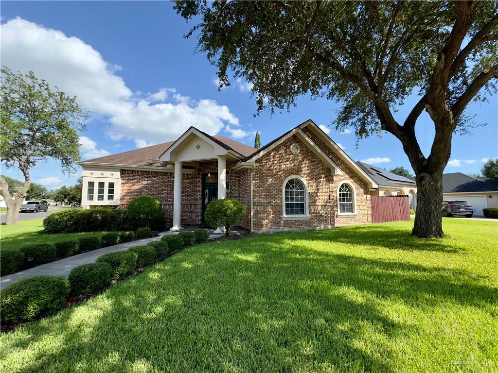 Single story home with a front yard