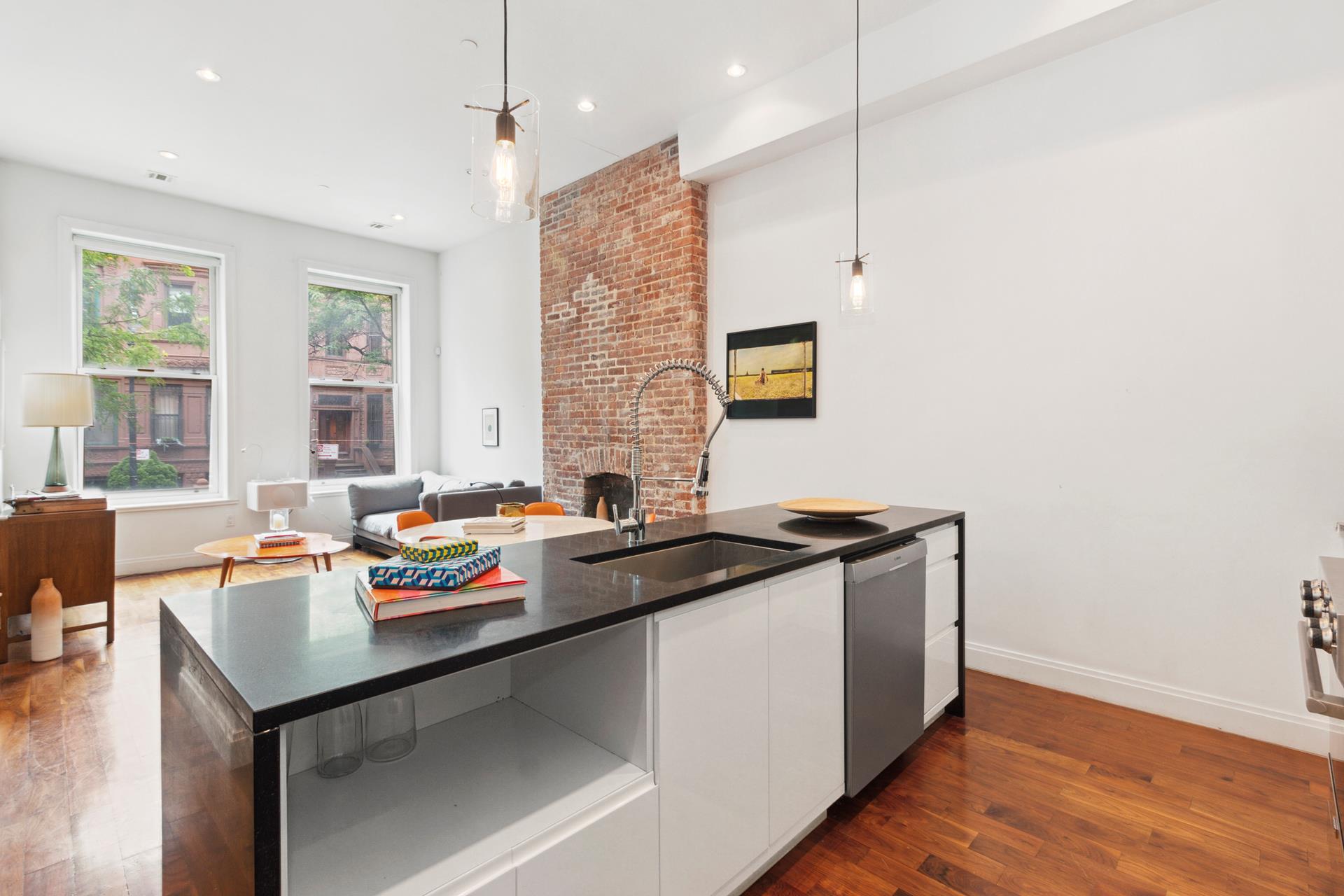 a kitchen with stainless steel appliances granite countertop a sink stove and wooden floor