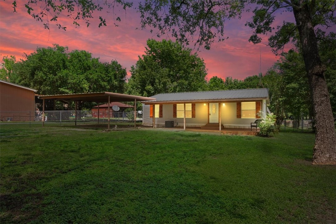 a view of a house with backyard and sitting area