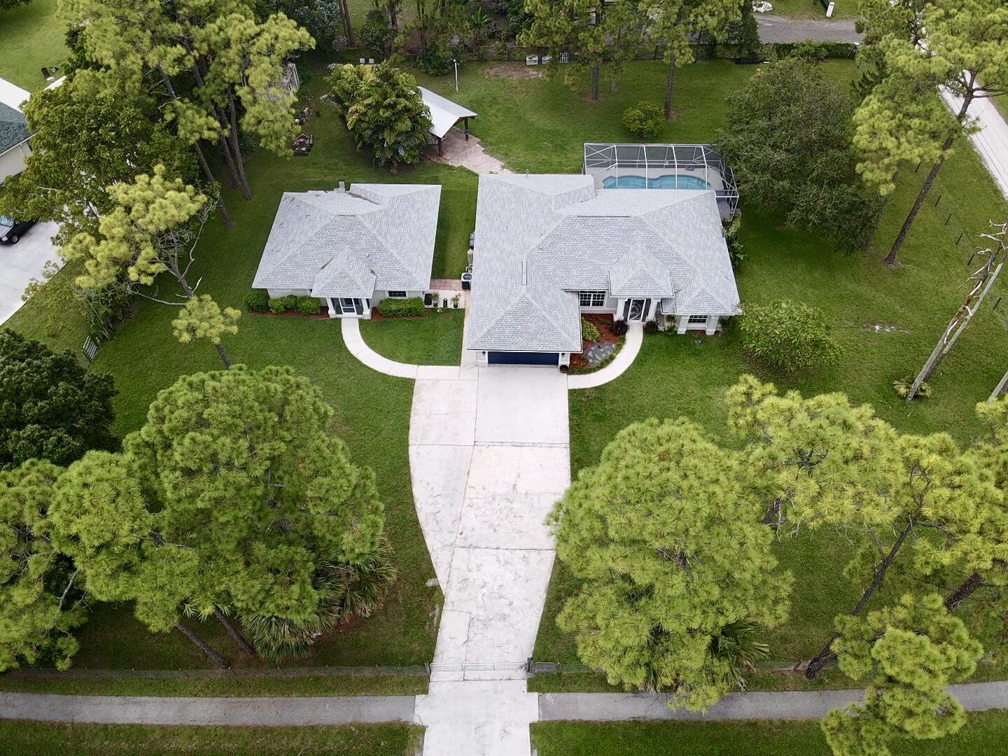 an aerial view of a house with garden space and street view