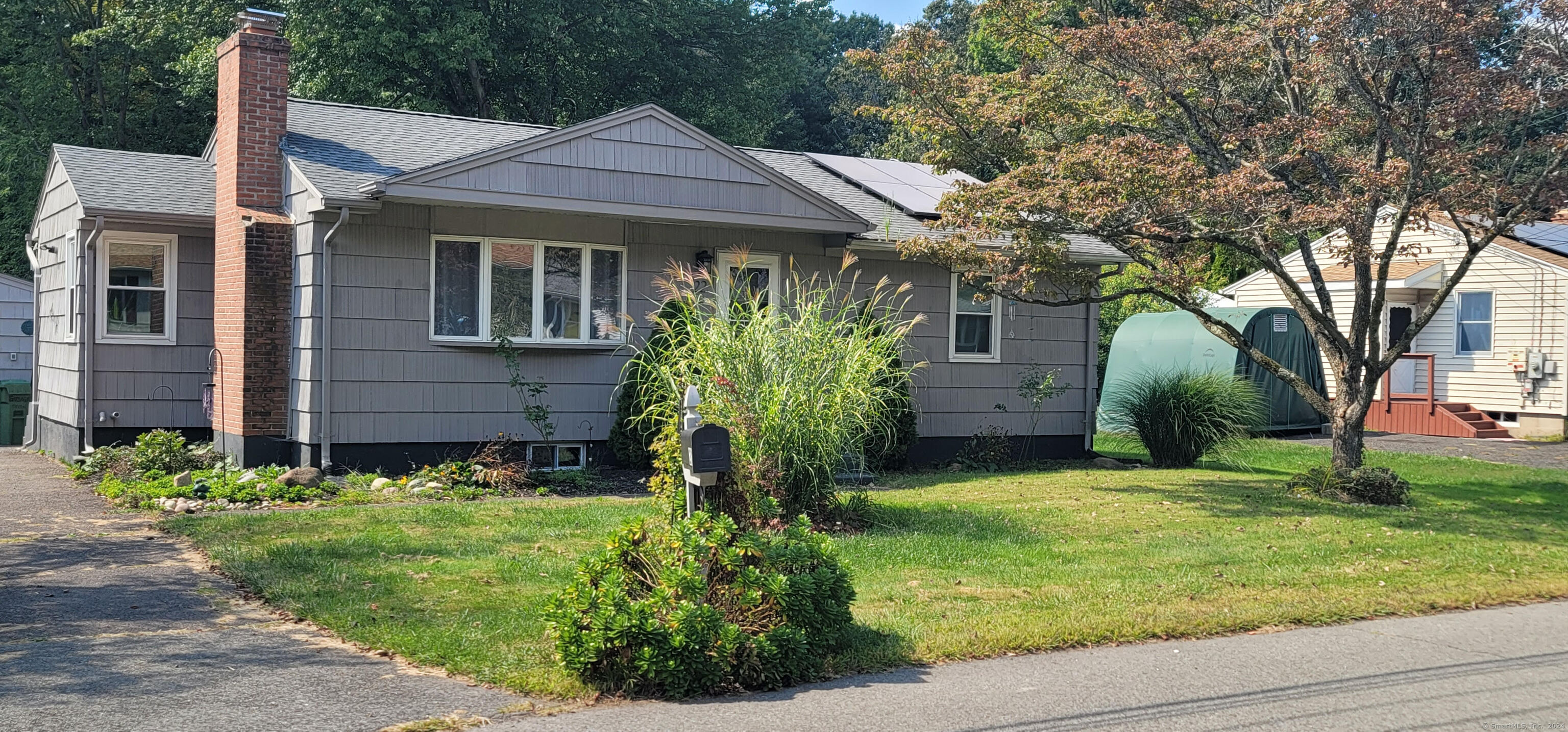 a front view of house with yard and green space