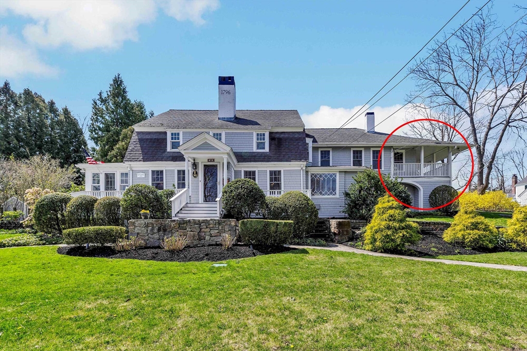 a front view of a house with yard and green space