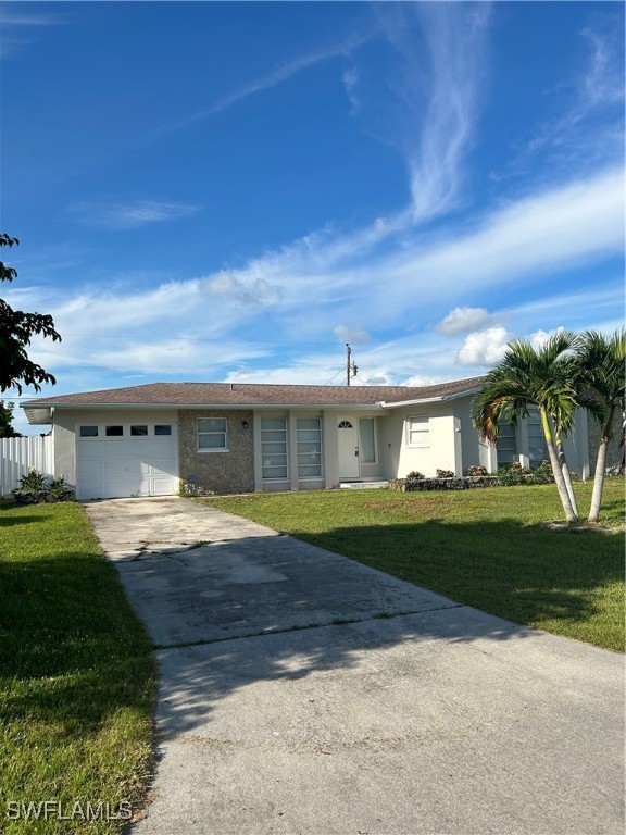 a view of a house with a yard and garage