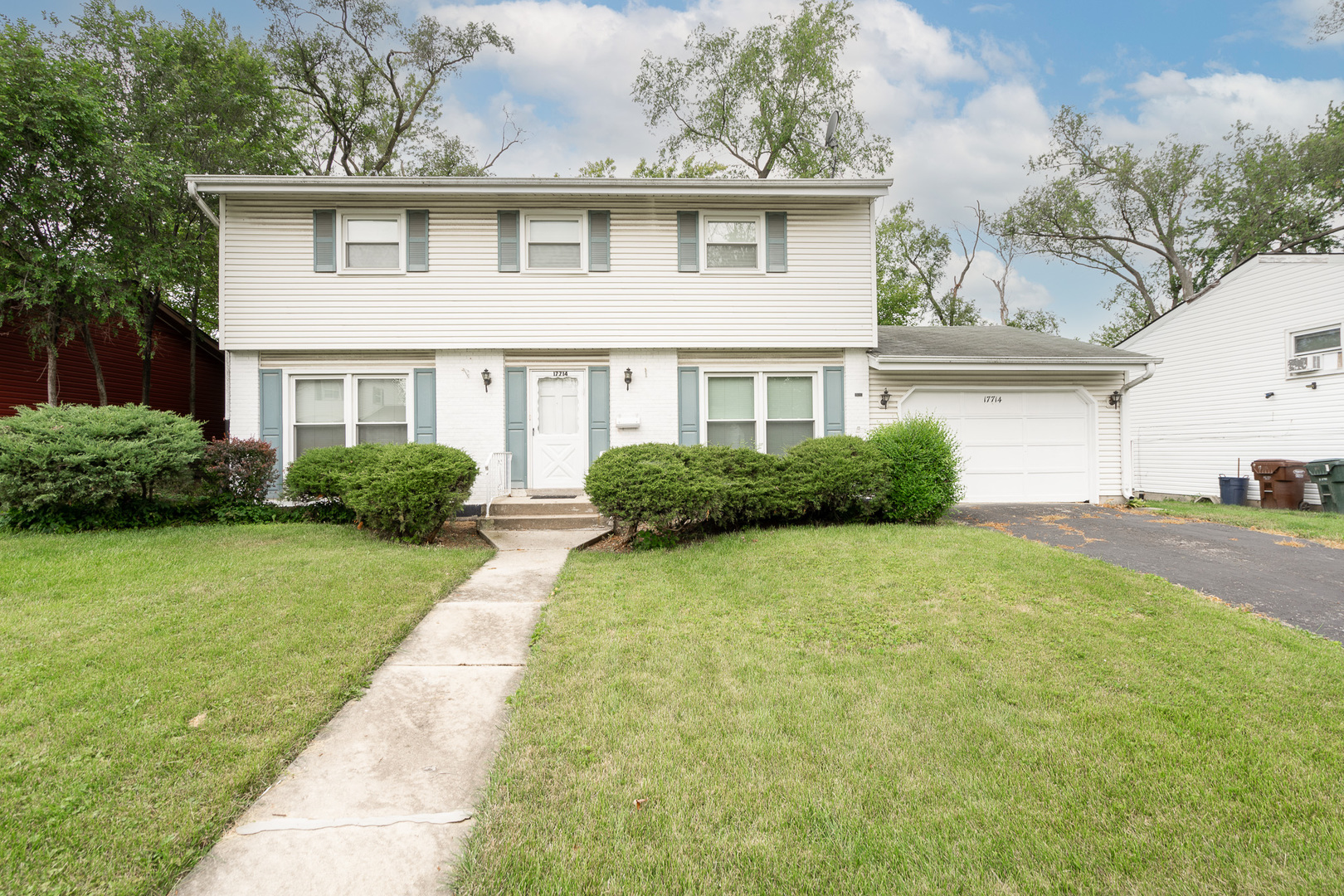 a front view of a house with a garden