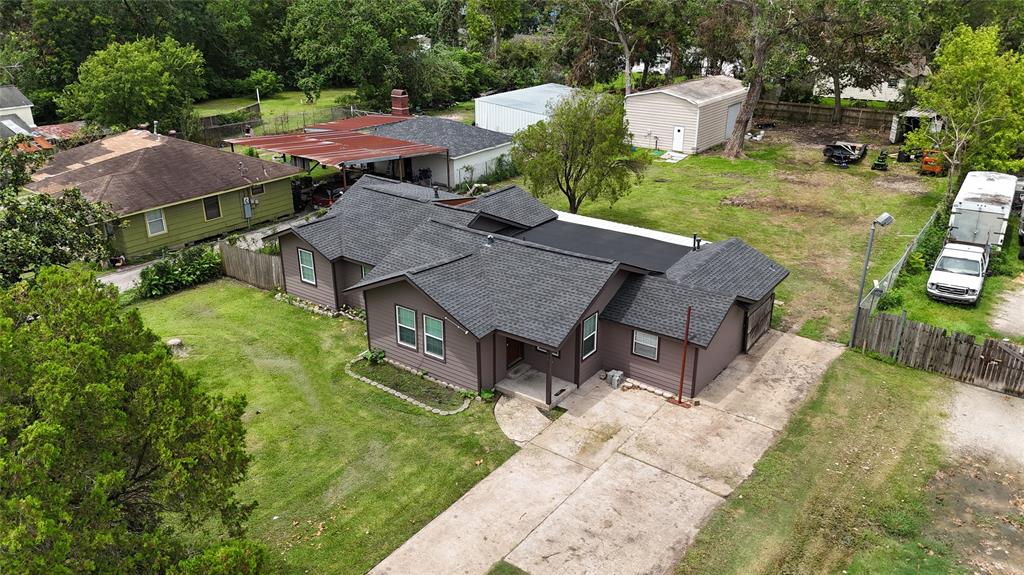 an aerial view of a house with garden space and street view