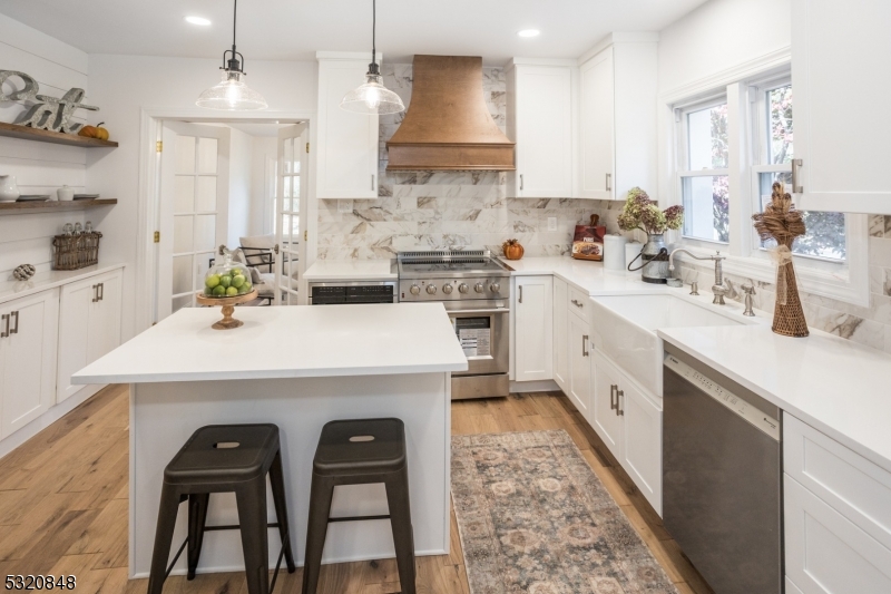 a kitchen with a sink a stove and cabinets