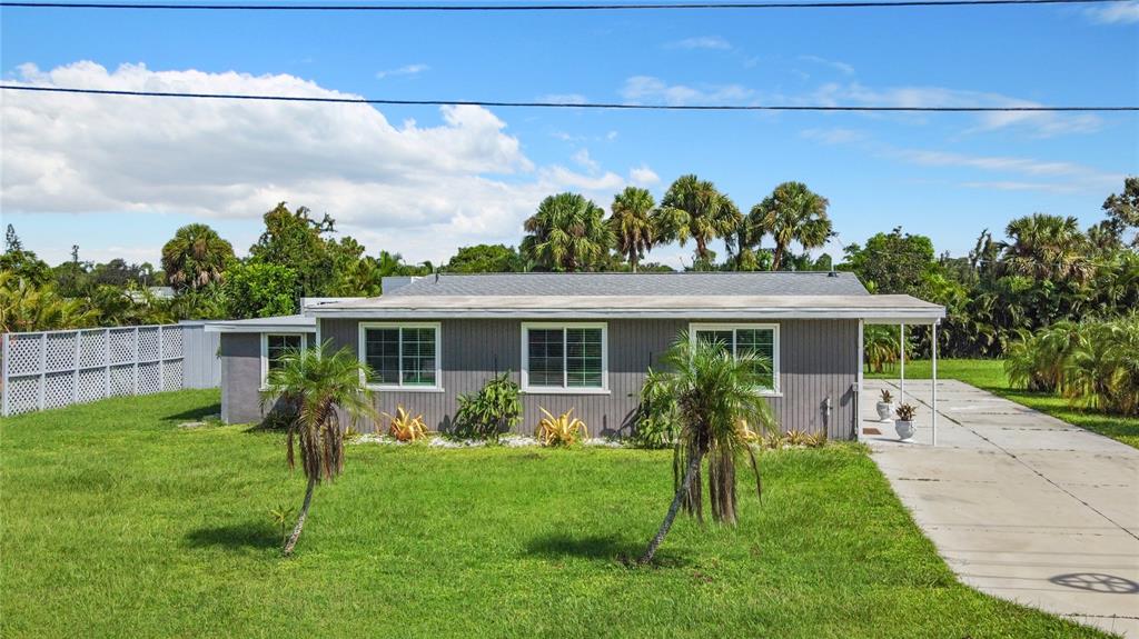 a view of a house with a yard and plants