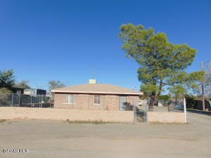 a front view of a house with a yard and a garage