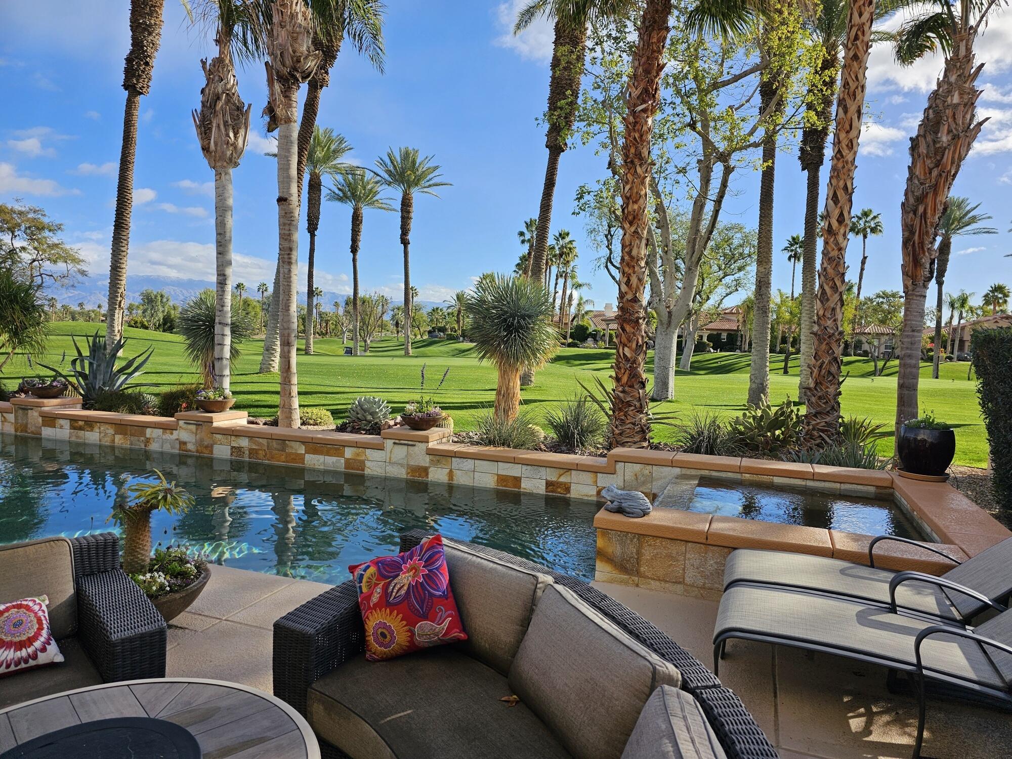 a view of a patio with couches chairs and a fire pit