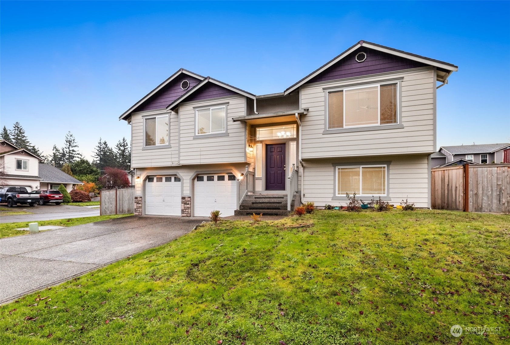 a front view of a house with a yard and garage