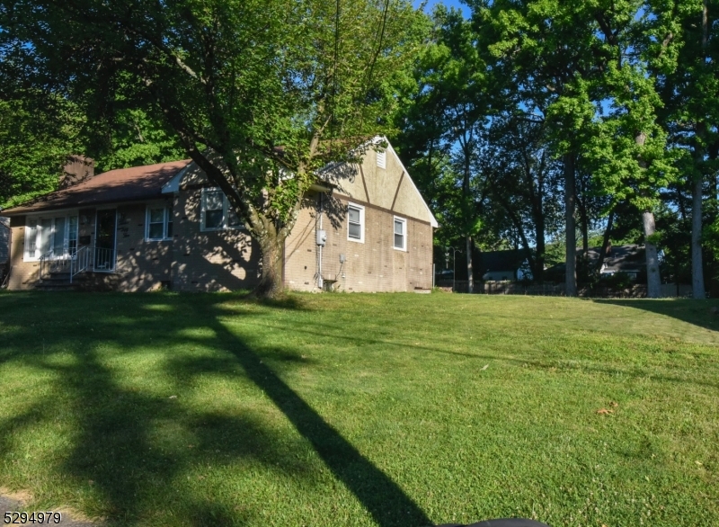 a view of house with backyard