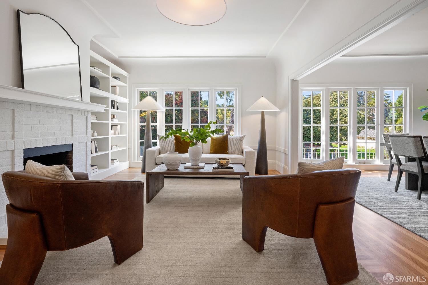 Expansive living-dining rooms with wall of west windows facing The Presidio