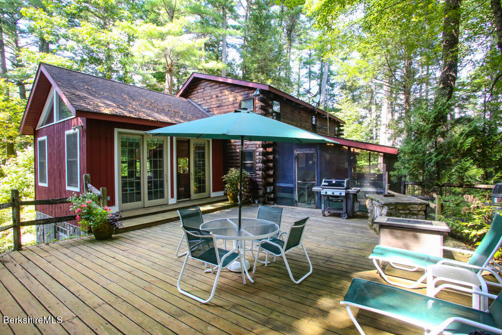 a view of a patio with table and chairs under an umbrella