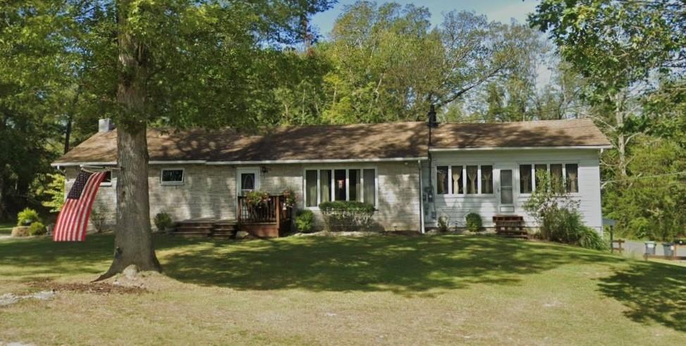 a front view of house with yard outdoor seating and green space