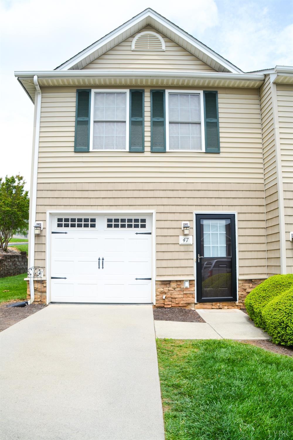 a view of a house with a yard and a garage