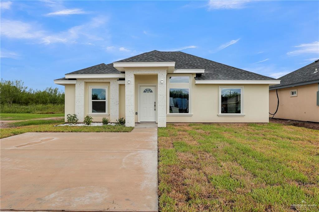 a front view of a house with a yard