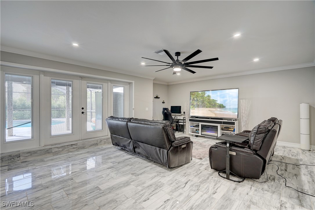 a living room with furniture a large window and a flat screen tv