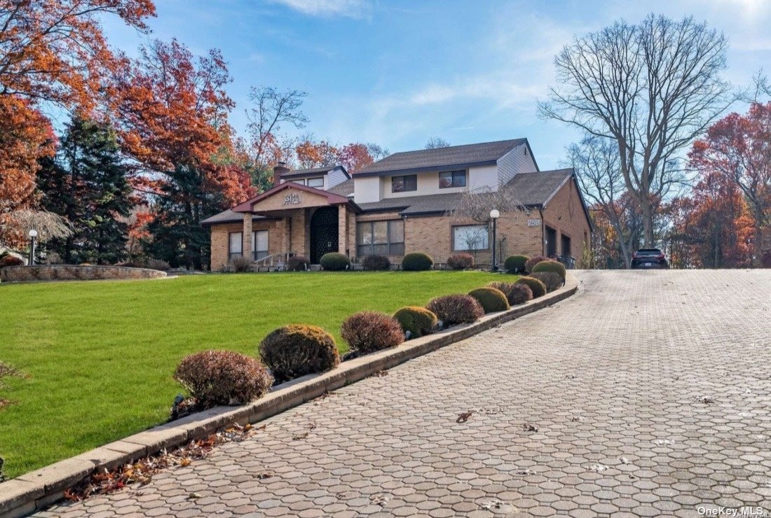 a front view of house with yard and green space