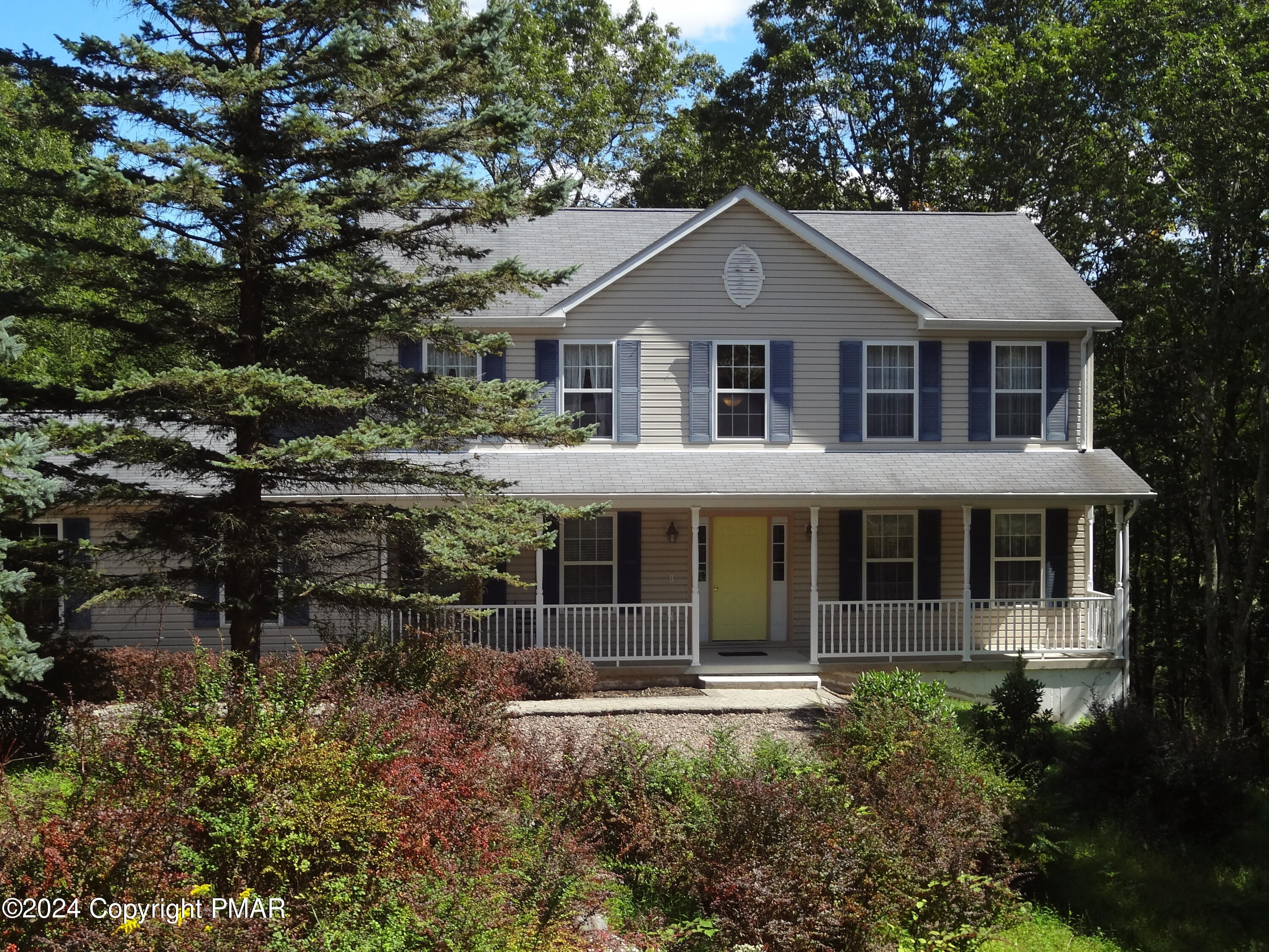 a front view of a house with a garden