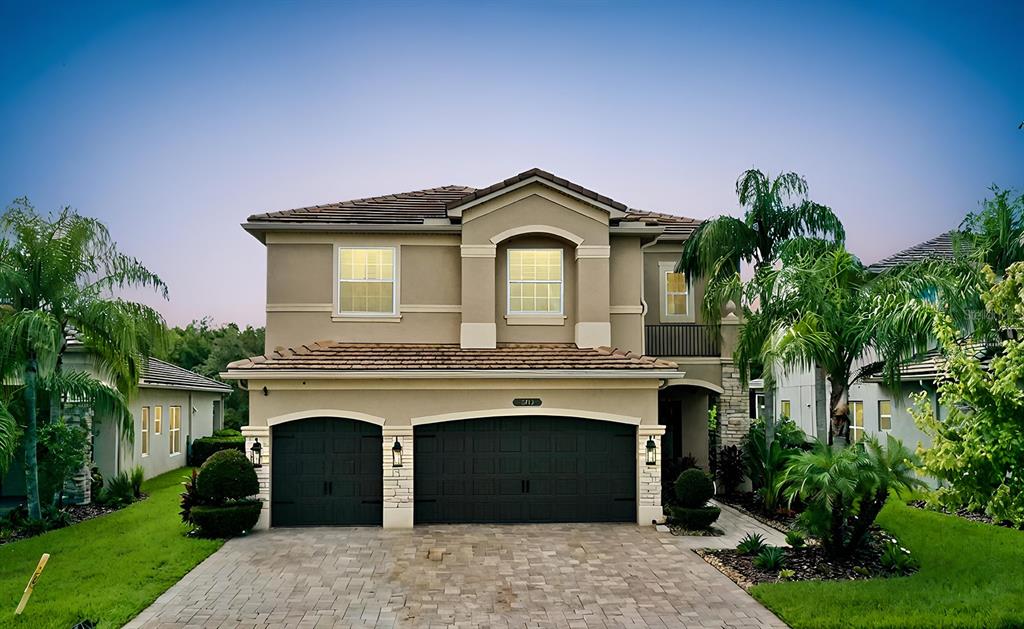 a front view of a house with a garden