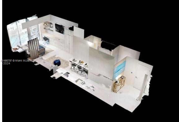 a white house with sink and black appliances