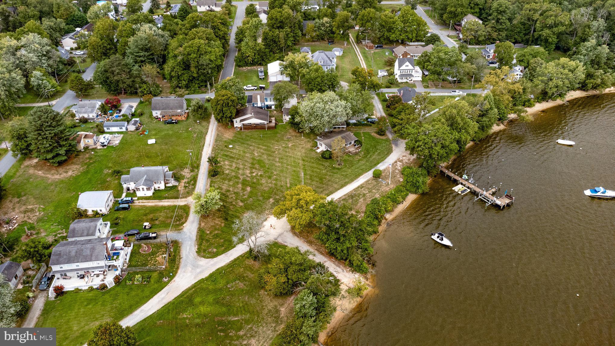 an aerial view of residential houses with outdoor space and swimming pool