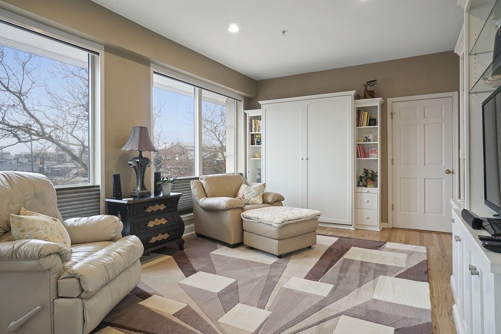 a living room with furniture and a large window