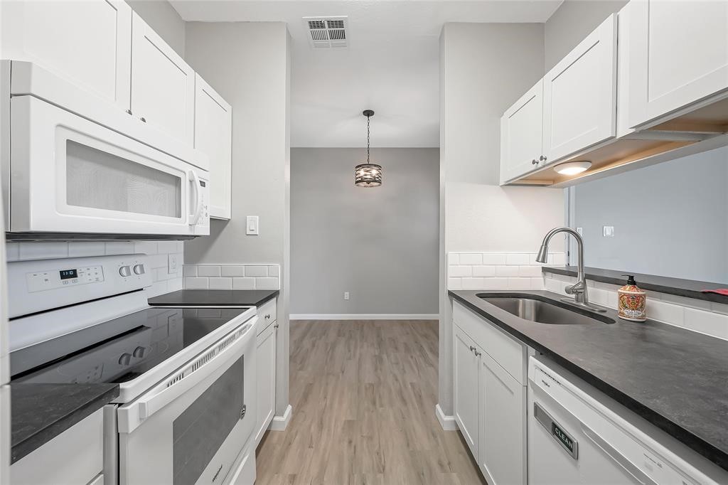 a kitchen with a sink and cabinets