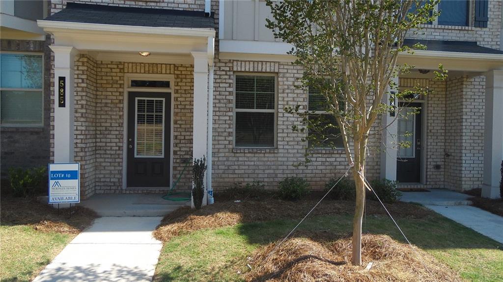 a front view of a house with a yard