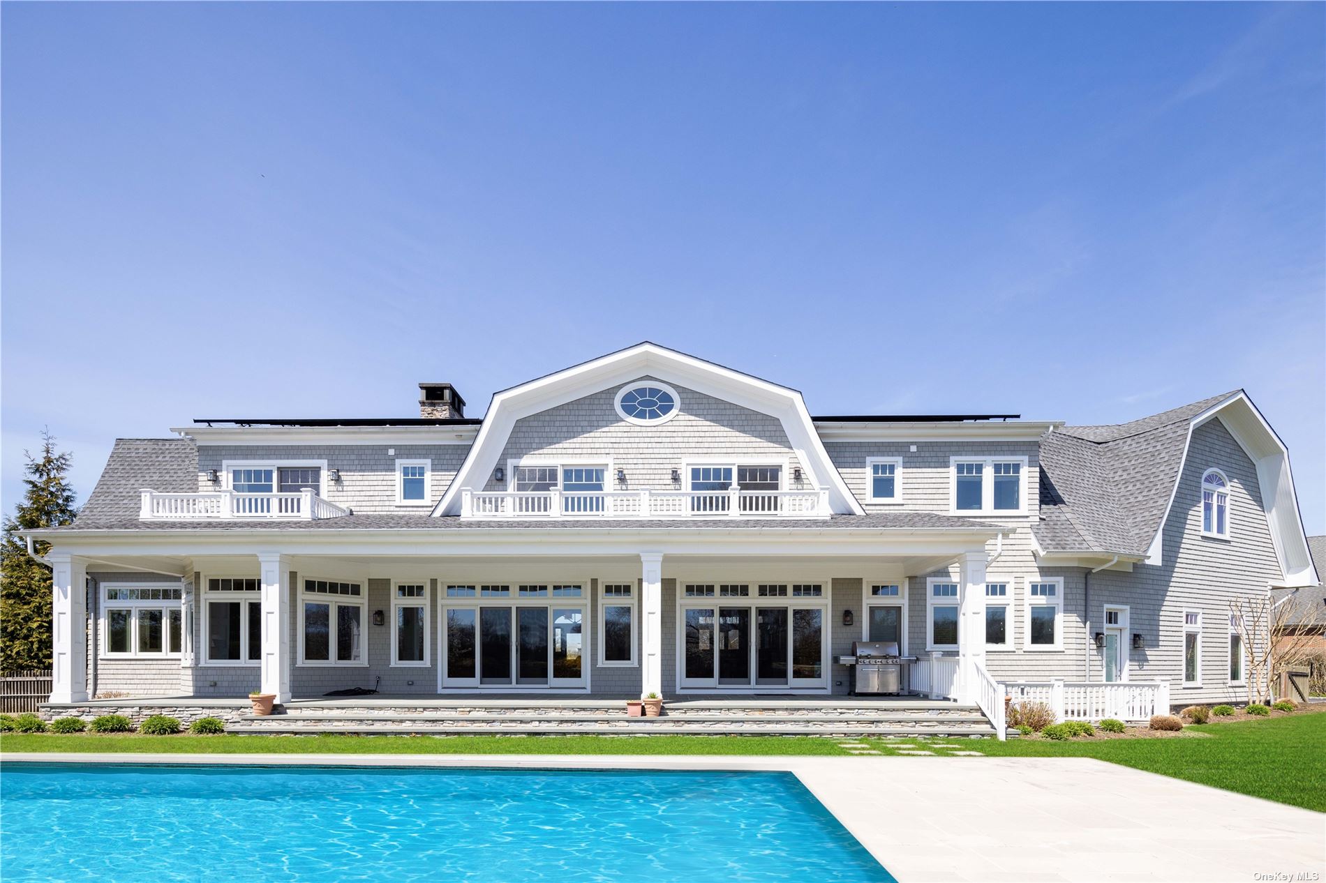 a front view of a house with swimming pool and porch