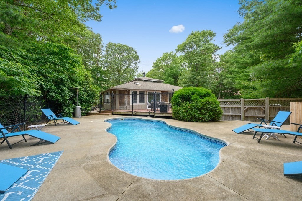 swimming pool view with a seating space