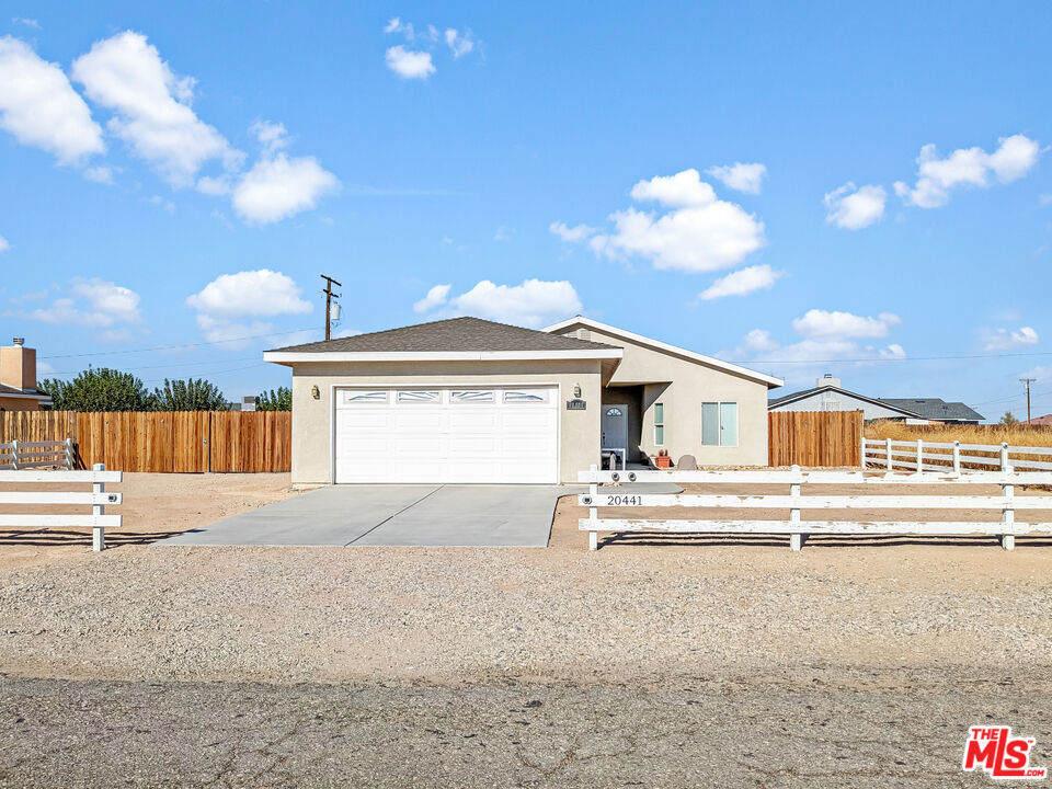 a view of house with yard and garage