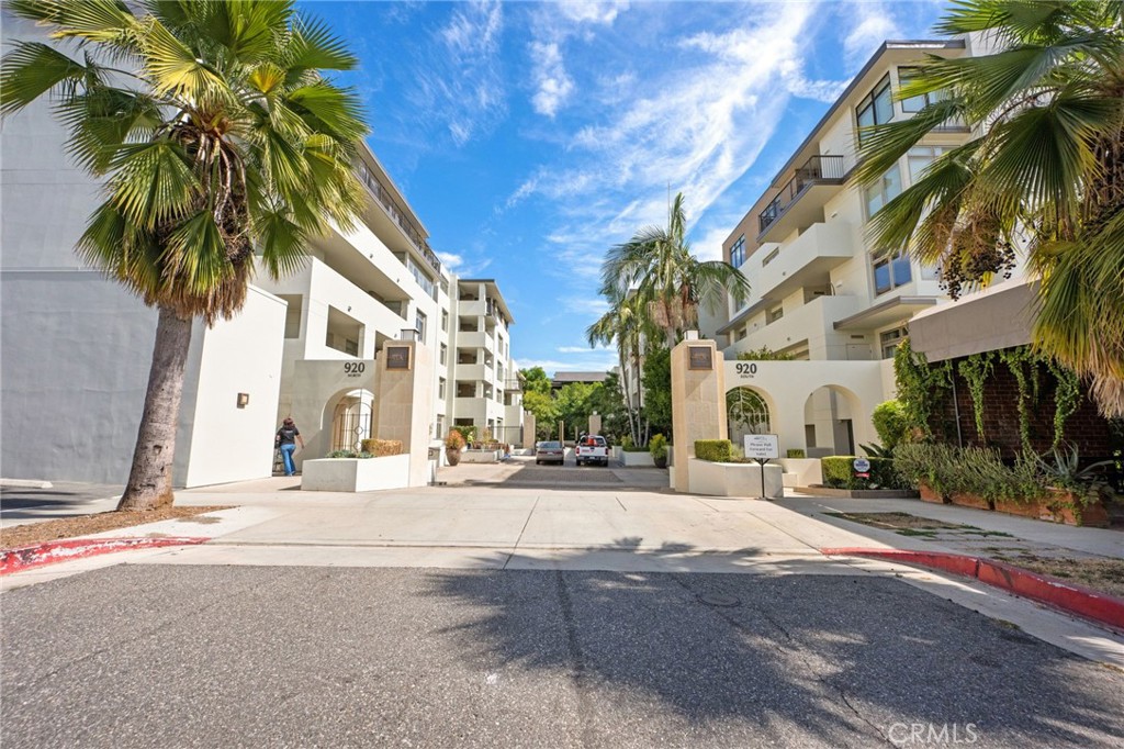 a row of palm trees in front of a building